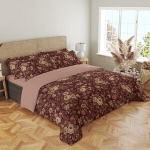 Angled full-bed view of burgundy bedding with densely scattered cream and dusty-pink roses, tiny blossoms and muted olive leaves, showing the pattern across the cover and pillows.