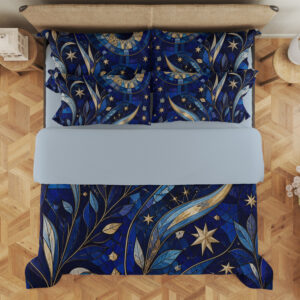 Overhead view of cobalt bedding with mosaic-like blue leaves, sweeping golden crescents, pale stars and a large circular celestial motif, with the design repeated on the pillows.