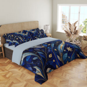 Angled full-bed view of cobalt bedding with mosaic-like blue leaves, sweeping golden crescents, pale stars and a large circular celestial motif, showing the pattern across the cover and pillows.