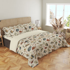 Angled full-bed view of ivory bedding with small watercolor reef fish in blue, yellow, coral and gray swimming among delicate sea plants, showing the pattern across the cover and pillows.