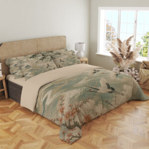 Angled full-bed view of bedding printed with white cranes flying over pale teal waves, framed by dark branches and rust-colored blossoms, showing the pattern across the cover and pillows.