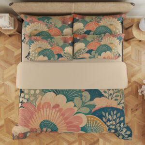 Overhead view of bedding printed with overlapping coral and ivory fan-shaped flowers, teal semicircles and pale leafy sprigs, with the design repeated on the pillows.