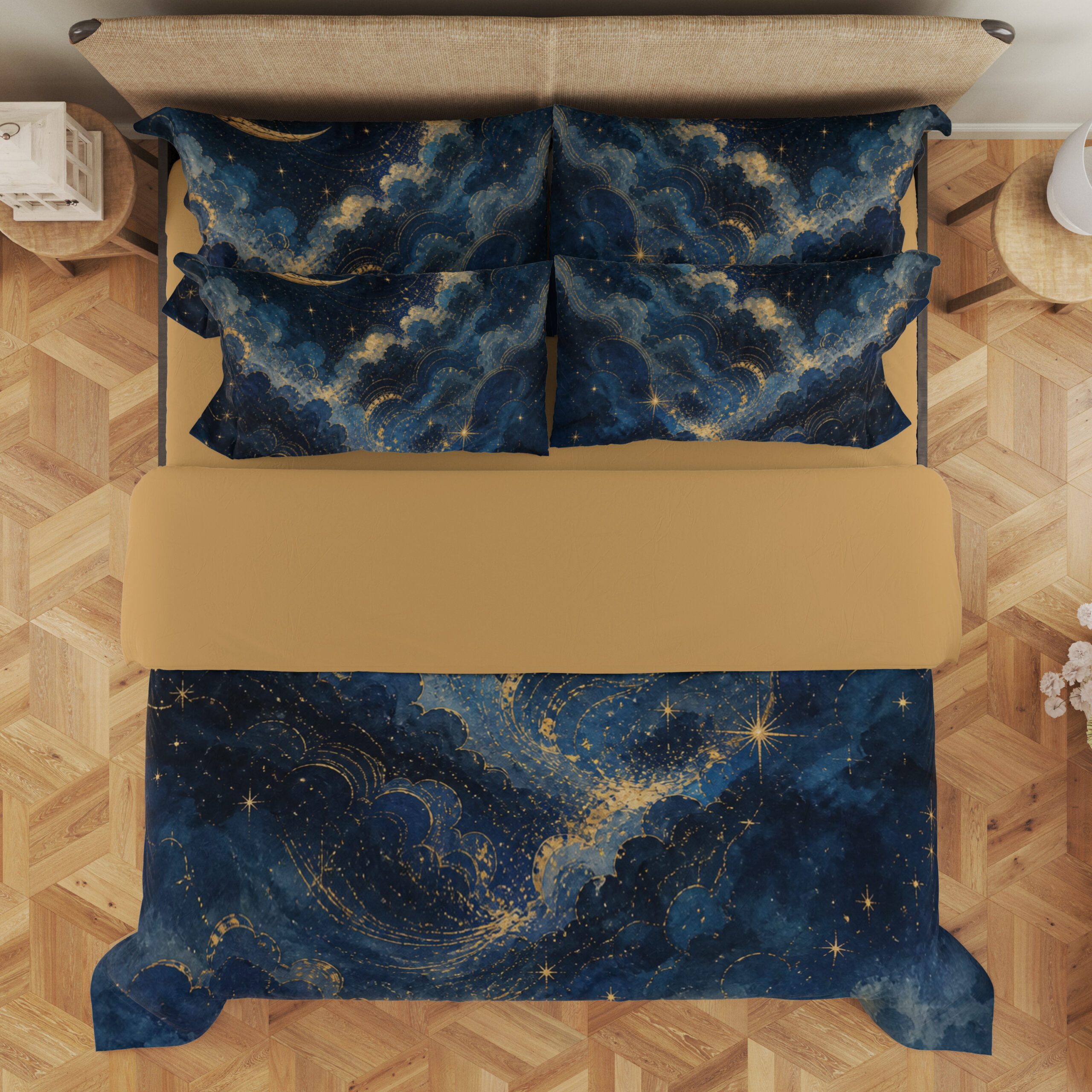 Overhead view of navy bedding with billowing blue cloud bands, fine golden edges, small stars and a slender crescent moon, with the design repeated on the pillows.