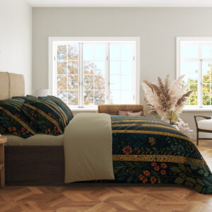 Side view of deep teal bedding with tall slender golden tree trunks, tiny coral flowers and scattered blue-green leaf sprigs, showing the print across the draped cover.