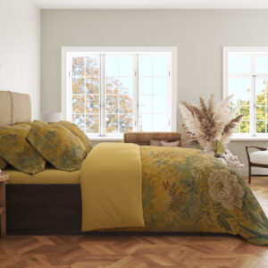 Side view of ochre yellow bedding, showing ivory flowers, muted green leaves and fine branches on the draped cover.