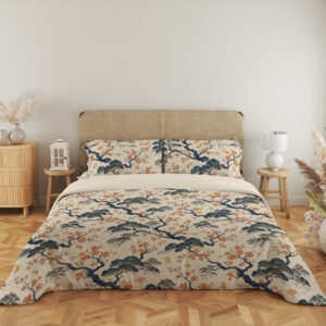 Full front view of cream bedding printed with twisting indigo branches, soft blue foliage and clusters of small coral blossoms beneath a beige headboard.