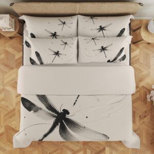 Overhead view of ivory bedding printed with large black and gray dragonflies, fine curving lines and scattered ink-like dots, with the design repeated on the pillows.