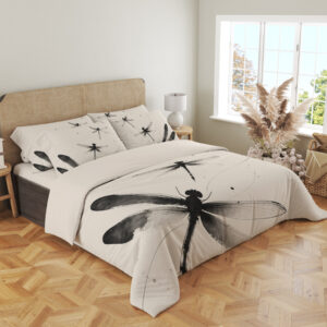Angled full-bed view of ivory bedding printed with large black and gray dragonflies, fine curving lines and scattered ink-like dots, showing the pattern across the cover and pillows.