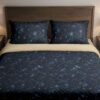 Front close view of deep navy bedding with tiny pale stars, fine constellation lines, crescent moons and soft blue nebula-like patches on the cover and matching pillows.