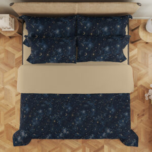 Overhead view of deep navy bedding with tiny pale stars, fine constellation lines, crescent moons and soft blue nebula-like patches, with the design repeated on the pillows.