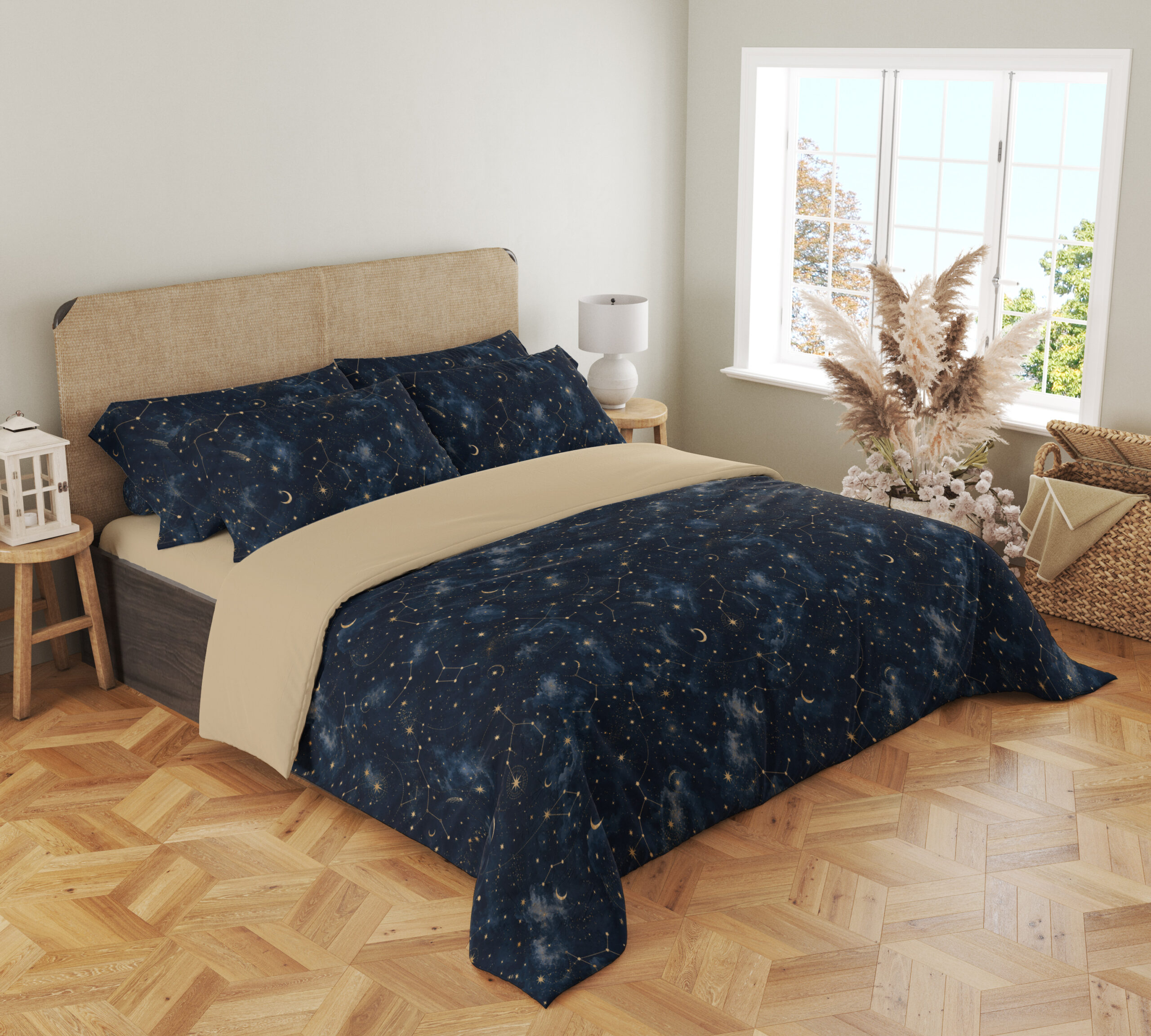 Angled full-bed view of deep navy bedding with tiny pale stars, fine constellation lines, crescent moons and soft blue nebula-like patches, showing the pattern across the cover and pillows.