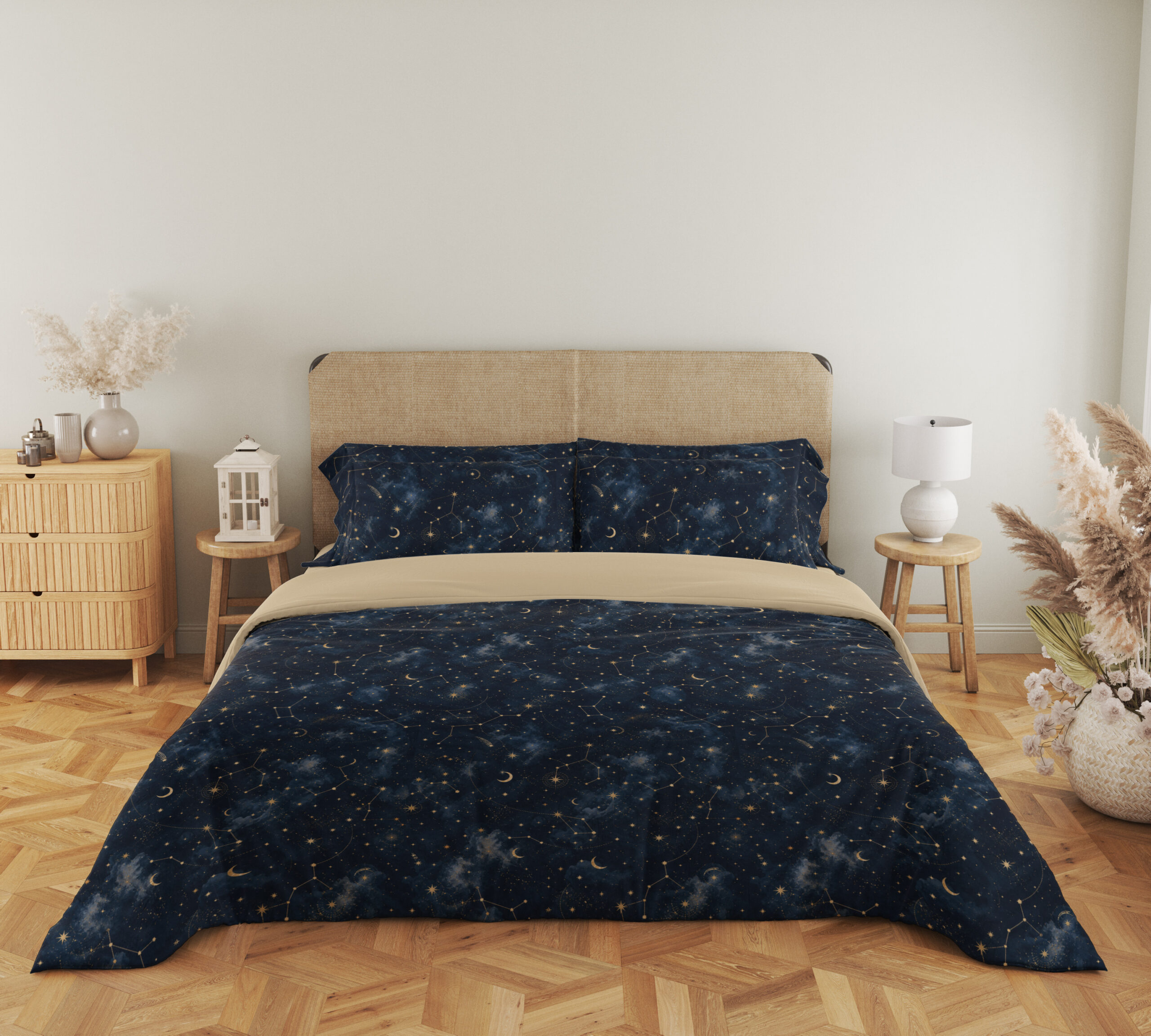 Full front view of deep navy bedding with tiny pale stars, fine constellation lines, crescent moons and soft blue nebula-like patches beneath a beige headboard.
