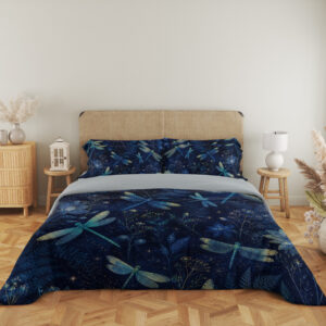 Full front view of navy bedding printed with turquoise and pale green dragonflies among blue flowers and fine botanical sprigs beneath a beige headboard.