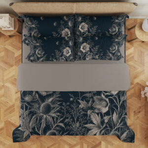 Overhead view of deep teal bedding with fine ivory line drawings of open flowers, spiky seed heads, fern-like leaves and tiny floating seeds, with the design repeated on the pillows.