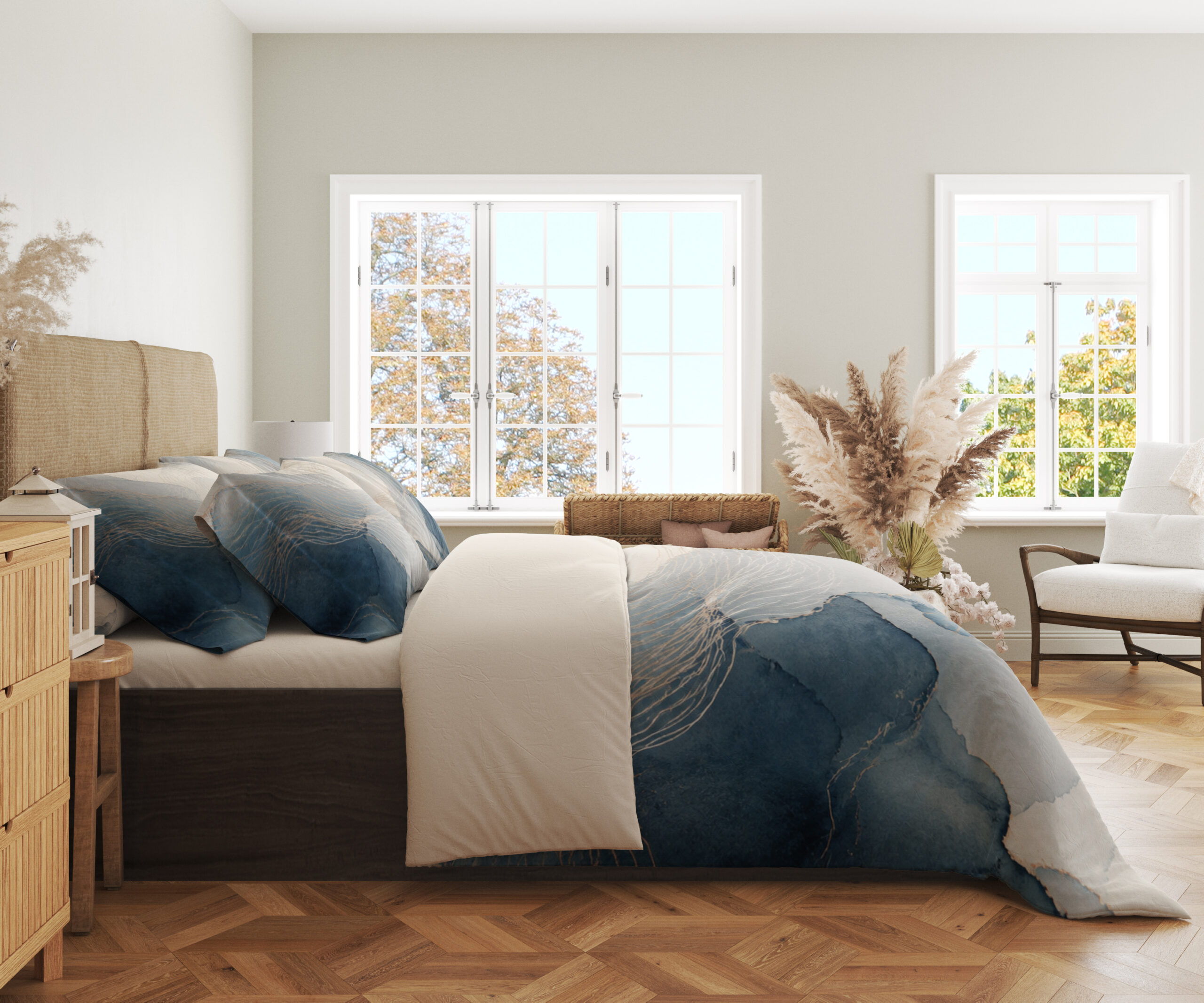 Side view of bedding printed with layered misty blue and gray watercolor contours, fine pale lines and an open ivory center, showing the print across the draped cover.