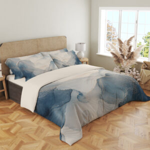 Angled full-bed view of bedding printed with layered misty blue and gray watercolor contours, fine pale lines and an open ivory center, showing the pattern across the cover and pillows.