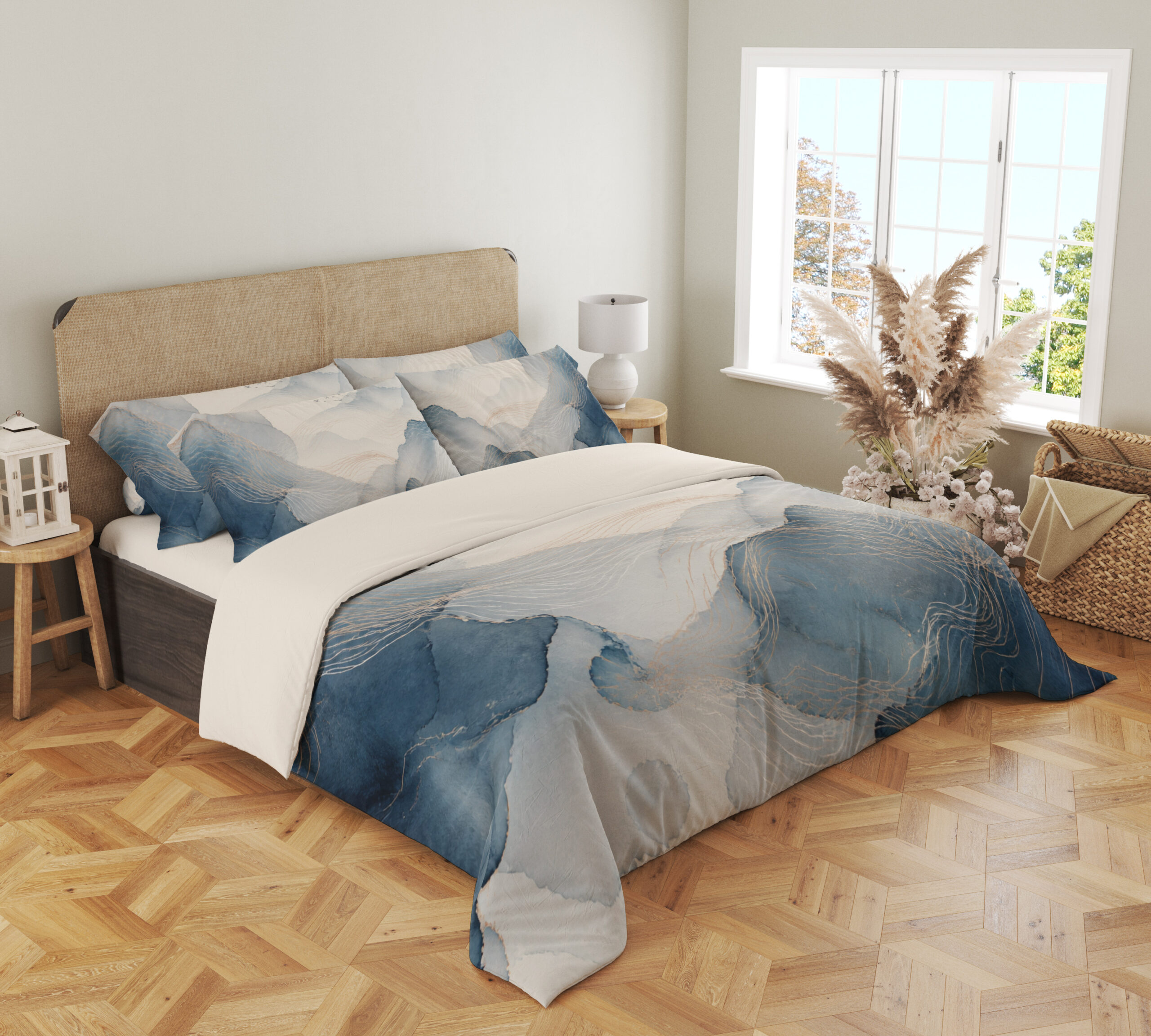 Angled full-bed view of bedding printed with layered misty blue and gray watercolor contours, fine pale lines and an open ivory center, showing the pattern across the cover and pillows.