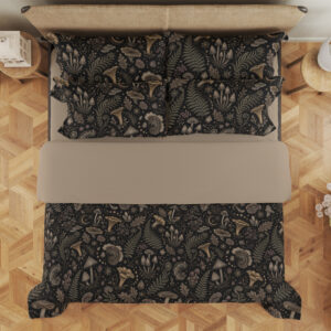 Overhead view of charcoal bedding printed with a dense repeat of taupe mushrooms, fern fronds, leaves and small woodland flowers, with the design repeated on the pillows.