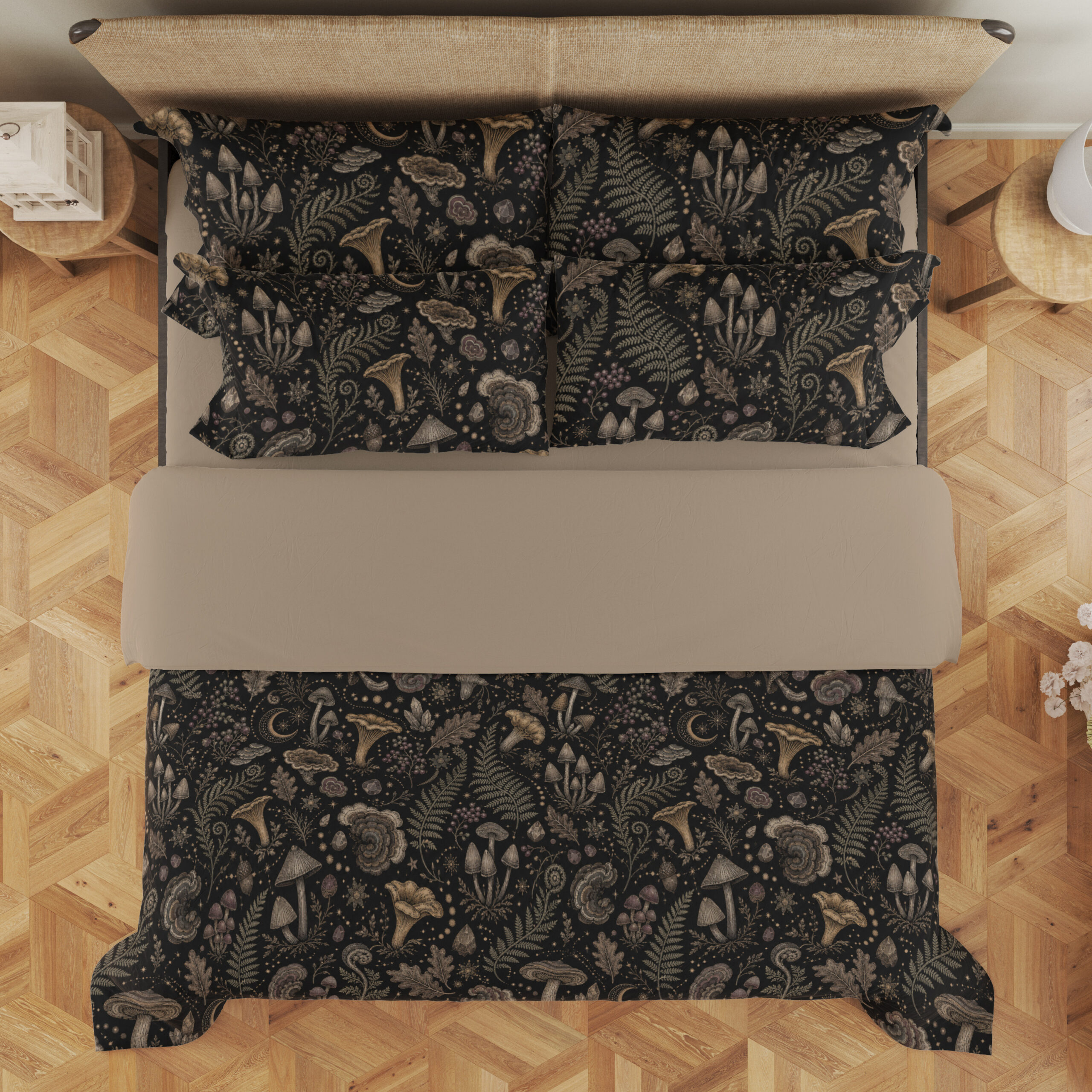 Overhead view of charcoal bedding printed with a dense repeat of taupe mushrooms, fern fronds, leaves and small woodland flowers, with the design repeated on the pillows.