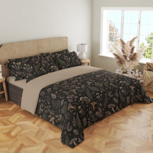 Angled full-bed view of charcoal bedding printed with a dense repeat of taupe mushrooms, fern fronds, leaves and small woodland flowers, showing the pattern across the cover and pillows.