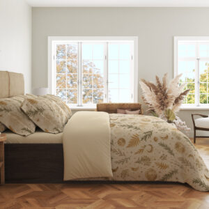 Side view of ivory bedding with small ochre fern fronds, muted green leafy sprigs, pale flowers and tiny crescent moons, showing the print across the draped cover.