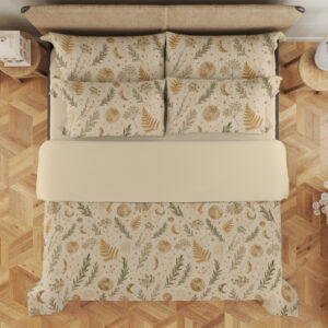Overhead view of ivory bedding with small ochre fern fronds, muted green leafy sprigs, pale flowers and tiny crescent moons, with the design repeated on the pillows.