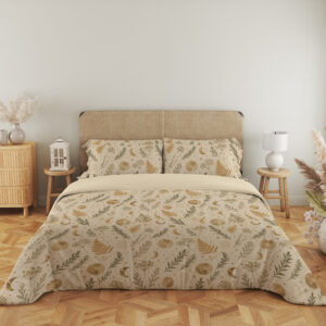 Full front view of ivory bedding with small ochre fern fronds, muted green leafy sprigs, pale flowers and tiny crescent moons beneath a beige headboard.
