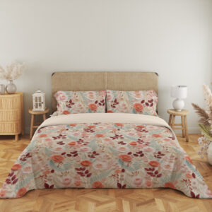 Full front view of ivory bedding with a dense delicate repeat of coral-pink roses, burgundy leaves, pale teal foliage and tiny peach blossoms beneath a beige headboard.