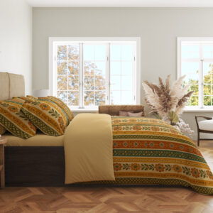 Side view of bedding with narrow vertical saffron, cream, orange and olive stripes filled with tiny folk flowers, leaf stems and dotted borders, showing the print across the draped cover.