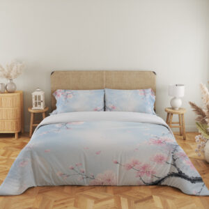 Full front view of pale blue bedding printed with delicate pink blossoms on dark branches and scattered petals around an open misty center beneath a beige headboard.