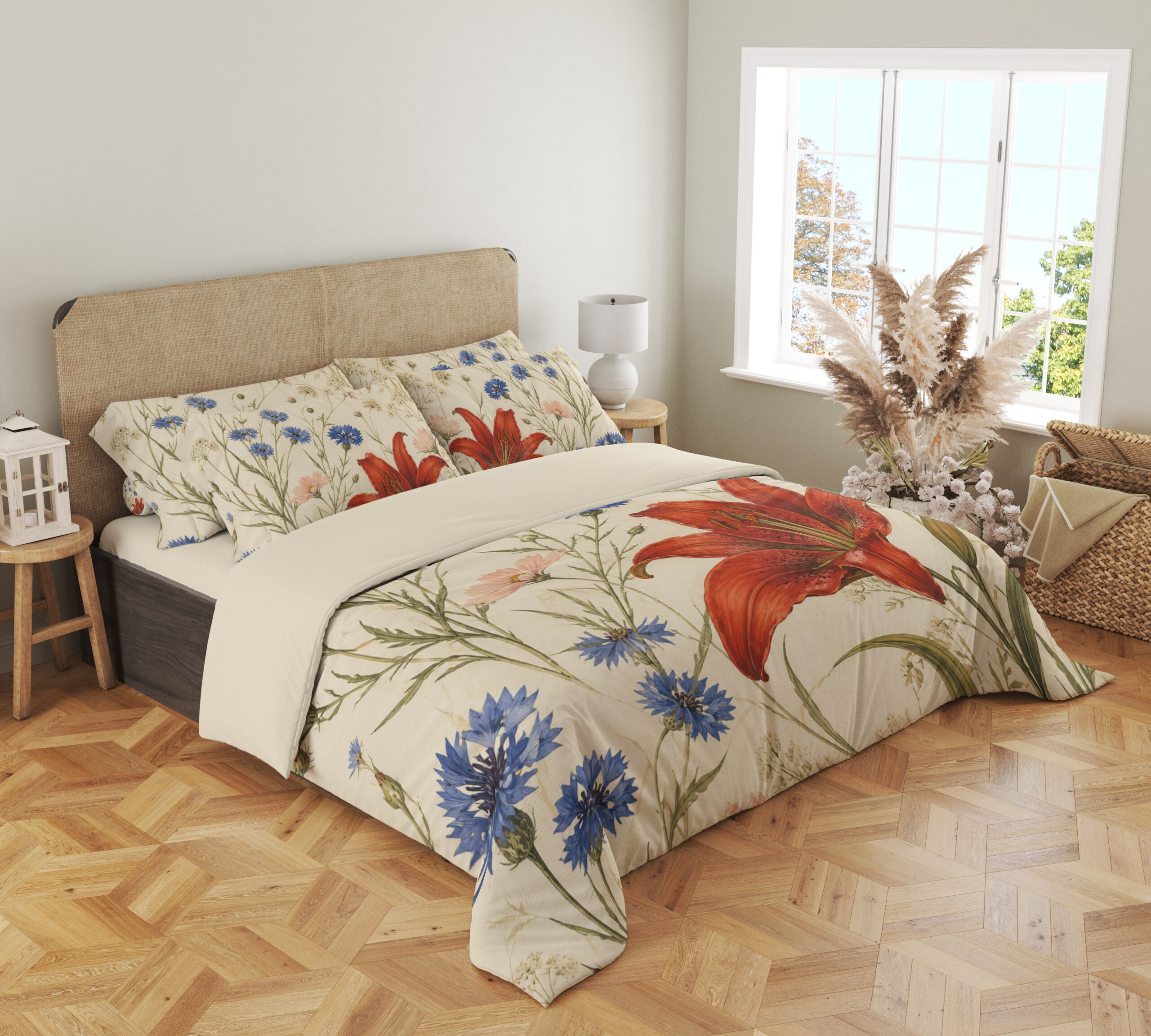 Angled full-bed view of cream bedding printed with large red lilies, blue cornflowers and fine green meadow stems, showing the pattern across the cover and pillows.