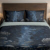 Front close view of midnight-blue bedding with delicate pale umbel flowers and fine meadow stems beneath a softly glowing star-speckled sky on the cover and matching pillows.