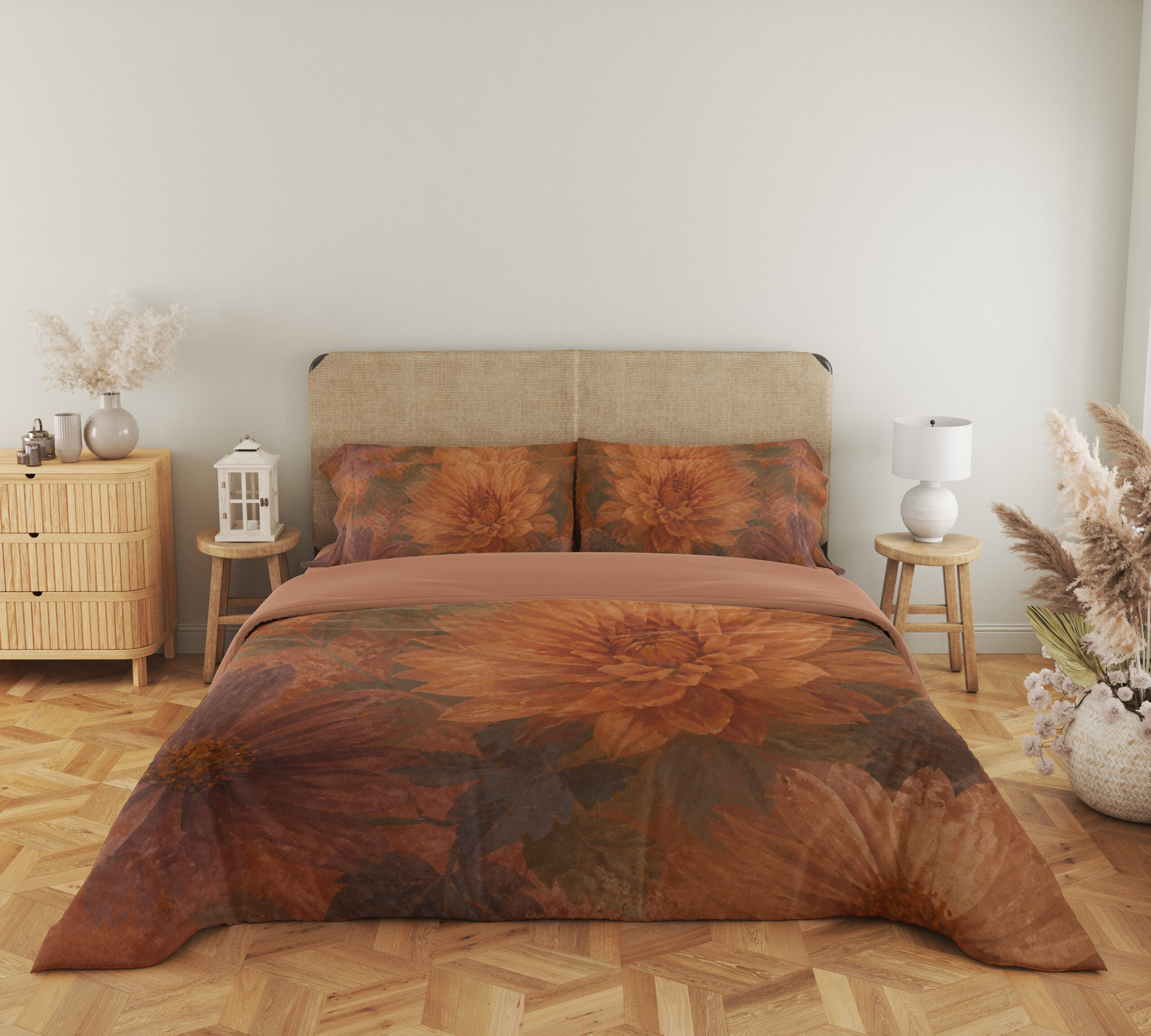 Full front view of terracotta bedding with large softly painted orange dahlias, muted burgundy petals and shadowy olive leaves beneath a beige headboard.