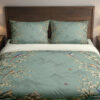 Celadon Blossom Aviary Bedding Set with celadon birds and cream blossoms — front view with dark wood headboard