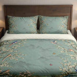 Celadon Blossom Aviary Bedding Set with celadon birds and cream blossoms — front view with dark wood headboard