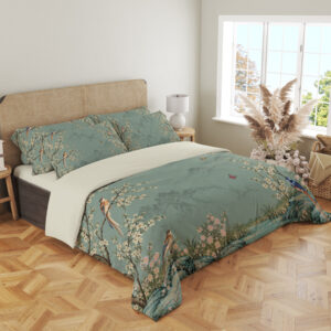 Celadon Blossom Aviary Bedding Set with celadon birds and cream blossoms — angled view in a light neutral bedroom