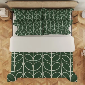 Overhead view of forest-green bedding, with small ivory leaf loops across the pillow arrangement and larger stems below the pale folded section.
