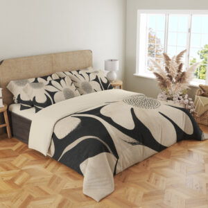 Angled full-bed view of charcoal bedding printed with oversized ivory flowers, curved petals and finely dotted centers, showing the pattern across the cover and pillows.