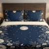 Midnight Moonflower Arbor Bedding Set with navy moon and ivory floral artwork — front view with dark wood headboard