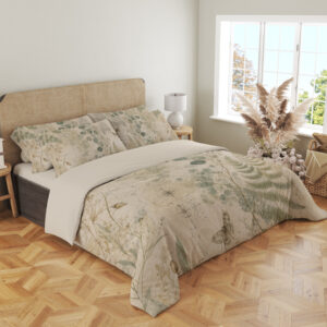 Angled full-bed view of parchment bedding printed with sage fern fronds, round eucalyptus-like leaves, delicate grasses and small moth motifs, showing the pattern across the cover and pillows.