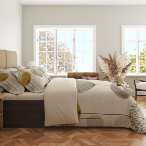 Side view of ivory bedding printed with widely spaced sage, mustard and gray rounded seedheads on slender stems, showing the print across the draped cover.