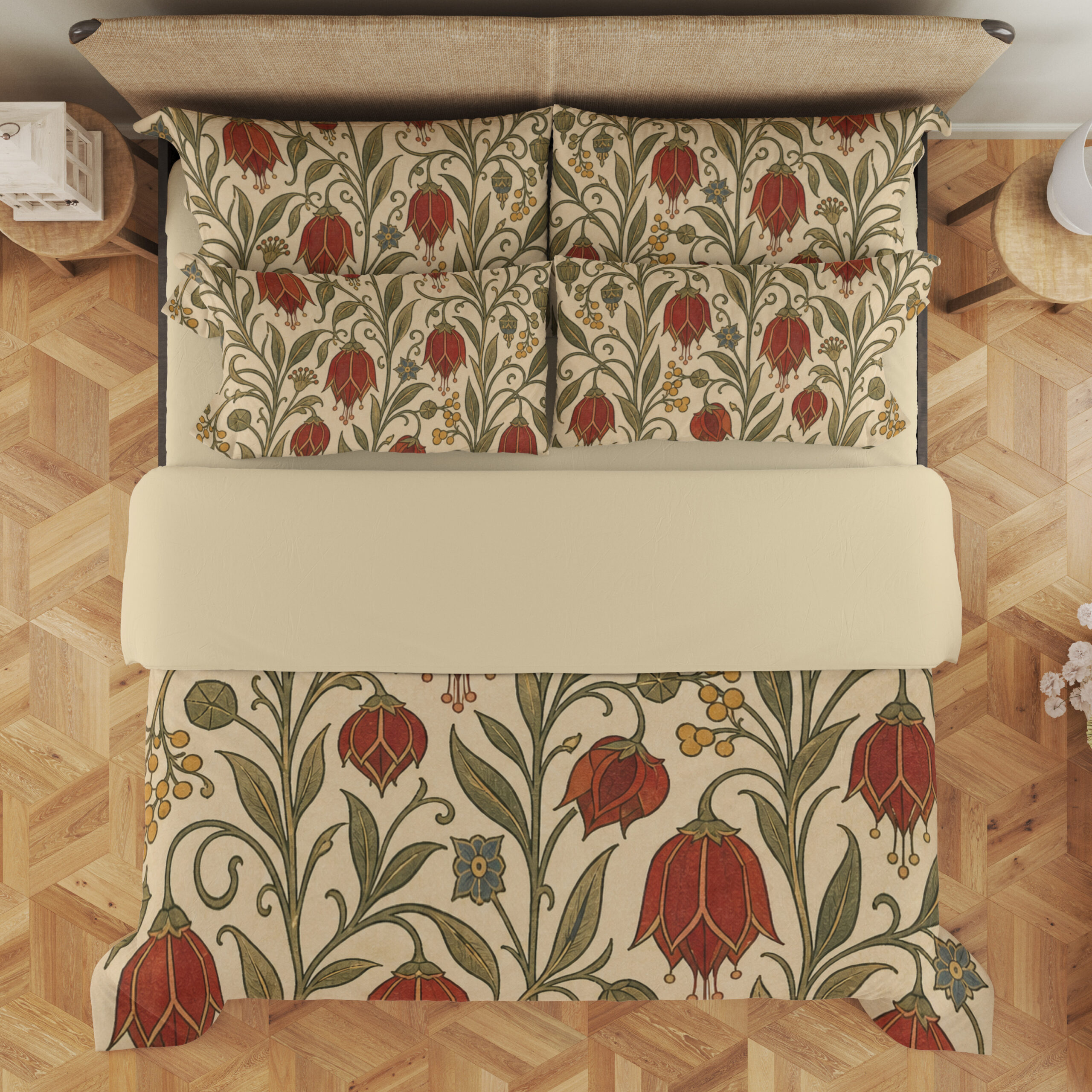 Overhead view of cream bedding printed with scarlet drooping bell-shaped flowers, small yellow berries and curling olive-green vines, with the design repeated on the pillows.