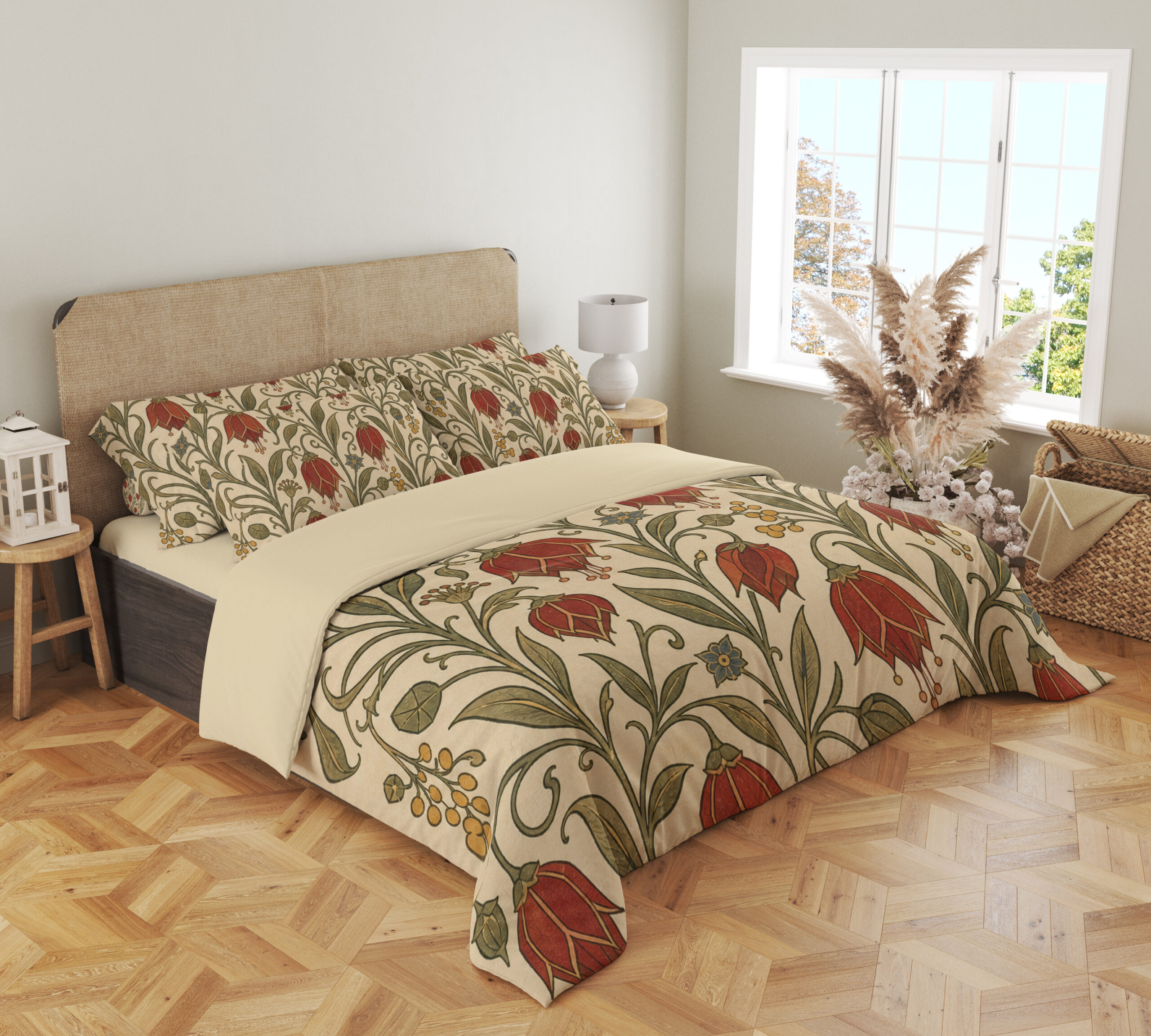 Angled full-bed view of cream bedding printed with scarlet drooping bell-shaped flowers, small yellow berries and curling olive-green vines, showing the pattern across the cover and pillows.