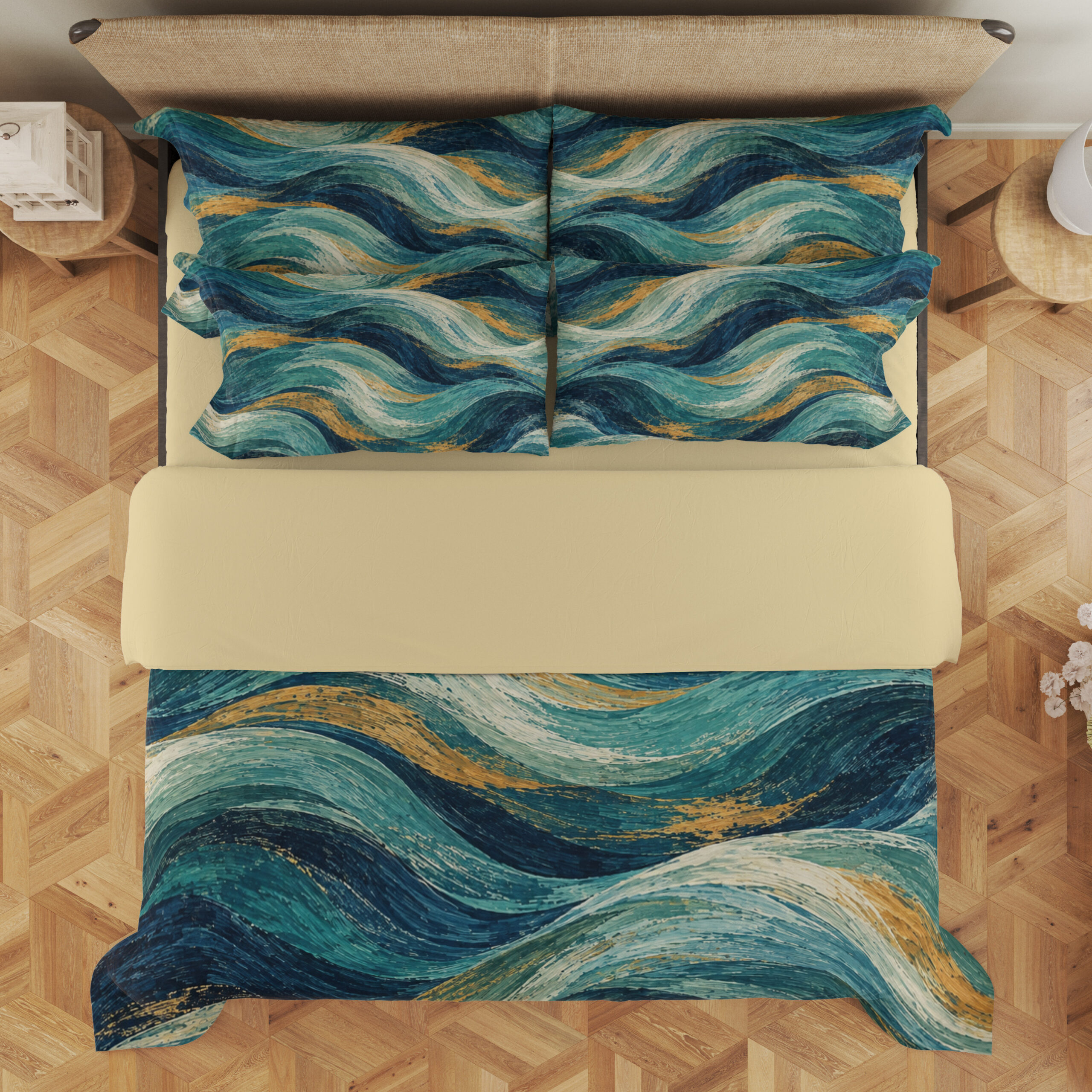 Overhead view of teal, navy and pale aqua wave-patterned bedding, with matching printed pillows and a plain cream fold.
