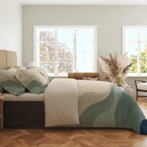 Side view of the cream and sage contour duvet cover with faint curved lines and matching pillowcases in a bright room with large windows and wood flooring.