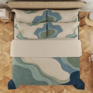 Overhead view of cream, sage and blue-gray contour shapes on the duvet cover and styled matching pillows, with faint curved lines and a pale fold.