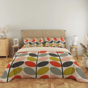 Full front view of cream bedding with alternating colorful oval leaves along dark stems, a narrow cream fold and matching multicolor pillows.