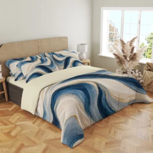 Three-quarter view of the ivory and blue painted ribbon duvet cover with gold-colored accents and matching pillows beside a window and dried grasses.
