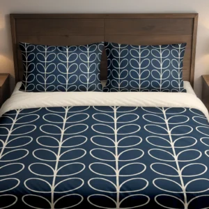 Navy bedding with cream oval leaf outlines arranged in vertical columns across the duvet and pillows, viewed closely from the front.