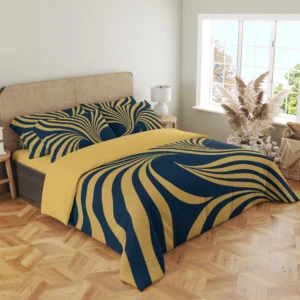 Three-quarter view of navy and gold-colored ribbon bedding, showing printed fan-pattern pillows and broad ribbons draping over the front corner.